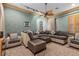 Entertainment room with comfortable sectional, chair and ottoman, and custom ceiling fan at 51 Avenida Sorrento, Henderson, NV 89011
