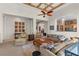 Bright living room featuring high ceilings, ceiling fan, and comfortable seating arrangement at 51 Avenida Sorrento, Henderson, NV 89011