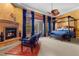 Luxurious main bedroom featuring a fireplace, sitting area, canopy bed, and access to an outdoor space at 51 Avenida Sorrento, Henderson, NV 89011