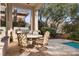 Charming covered patio with an outdoor dining set, featuring a built-in BBQ, and a serene view of the pool at 51 Avenida Sorrento, Henderson, NV 89011