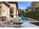 Inviting pool and spa with stone surround, perfect for outdoor relaxation and entertaining, plus covered patio at 51 Avenida Sorrento, Henderson, NV 89011