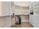 Custom walk-in closet with white shelving, drawers, hanging rods, and carpeted floors at 51 Avenida Sorrento, Henderson, NV 89011
