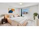 Inviting bedroom with dark wood accents, a large window, and soft carpet flooring at 5976 Rockway Glen Ave, Las Vegas, NV 89141