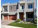 Modern two-story home with a three-car garage, stone accents, and manicured lawn at 5976 Rockway Glen Ave, Las Vegas, NV 89141