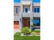 Modern home featuring a gray stone facade, orange door, and well-maintained landscaping at 5976 Rockway Glen Ave, Las Vegas, NV 89141