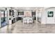 Open-concept kitchen features dark cabinets, stainless steel appliances, and sliding doors to the patio at 5976 Rockway Glen Ave, Las Vegas, NV 89141