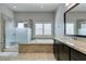Elegant bathroom with granite countertops, soaking tub, and glass-enclosed shower at 6085 Ryan Ranch Ave, Las Vegas, NV 89130