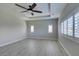 Bright, airy bedroom with a tray ceiling, ceiling fan and shuttered windows offering lots of light at 6085 Ryan Ranch Ave, Las Vegas, NV 89130