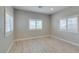 Bright bedroom features multiple windows with white blinds, light-colored walls and flooring at 6085 Ryan Ranch Ave, Las Vegas, NV 89130