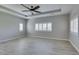 Bright, airy bedroom with a tray ceiling, ceiling fan and shuttered windows offering lots of light at 6085 Ryan Ranch Ave, Las Vegas, NV 89130