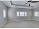 Neutral bedroom with a tray ceiling, ceiling fan and shuttered windows offering an abundance of light at 6085 Ryan Ranch Ave, Las Vegas, NV 89130