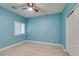 Cozy bedroom with neutral paint, one shuttered window, ceiling fan and white closet door at 6085 Ryan Ranch Ave, Las Vegas, NV 89130
