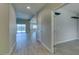 Bright entryway with wood-look flooring and an open floor plan leading to the living area at 6085 Ryan Ranch Ave, Las Vegas, NV 89130