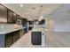 Modern kitchen features stainless appliances, center island and stylish pendant lighting at 6085 Ryan Ranch Ave, Las Vegas, NV 89130