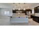 Modern kitchen features stainless appliances, center island and stylish pendant lighting at 6085 Ryan Ranch Ave, Las Vegas, NV 89130