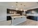 Modern kitchen features stainless appliances, center island and stylish pendant lighting at 6085 Ryan Ranch Ave, Las Vegas, NV 89130