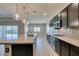 Bright kitchen with granite countertops, stainless steel appliances, dark wood cabinets, and pendant lighting at 6085 Ryan Ranch Ave, Las Vegas, NV 89130