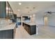 Modern kitchen features stainless appliances, center island and stylish pendant lighting at 6085 Ryan Ranch Ave, Las Vegas, NV 89130