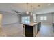 Spacious kitchen featuring a large island, granite countertops, stainless steel appliances, and backyard access at 6085 Ryan Ranch Ave, Las Vegas, NV 89130