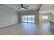 Spacious living room featuring a tray ceiling, ceiling fan, and sliding glass doors at 6085 Ryan Ranch Ave, Las Vegas, NV 89130