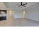 Expansive living area with wood-look floors, open layout, and access to other rooms at 6085 Ryan Ranch Ave, Las Vegas, NV 89130
