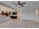 Open living space featuring an island kitchen, granite countertops, and wood-look flooring at 6085 Ryan Ranch Ave, Las Vegas, NV 89130