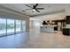 Open-concept living area with an adjacent kitchen, wood-look floors, and natural light at 6085 Ryan Ranch Ave, Las Vegas, NV 89130