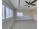 Open living room with shuttered windows, neutral paint, lots of natural light and contemporary ceiling fan at 6085 Ryan Ranch Ave, Las Vegas, NV 89130