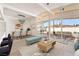 Open living room with contemporary decor, light wood floors, and a view of the backyard patio at 6205 Hargrove Ave, Las Vegas, NV 89107