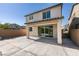 Backyard showcasing a covered patio, a concrete area, block wall fencing and a view of surrounding houses at 6442 Kobe Knoll Ct, Las Vegas, NV 89141