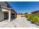 Backyard featuring a covered patio, large concrete area, block wall fencing and mature landscaping at 6442 Kobe Knoll Ct, Las Vegas, NV 89141