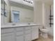 Bathroom with double sinks, large mirror, quartz countertop and tiled floor at 6442 Kobe Knoll Ct, Las Vegas, NV 89141