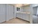 Bathroom boasting a double sink vanity with white cabinets, ample storage, and tiled flooring at 6442 Kobe Knoll Ct, Las Vegas, NV 89141