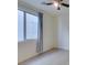 Neutral bedroom with large windows, tile floors, ceiling fan and light-blocking curtains at 6442 Kobe Knoll Ct, Las Vegas, NV 89141