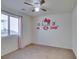 bedroom with neutral carpet, ceiling fan and a wall decorated with Hello Kitty decal at 6442 Kobe Knoll Ct, Las Vegas, NV 89141