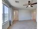 Bedroom featuring a ceiling fan, a large window, ensuite bathroom and walk-in closet at 6442 Kobe Knoll Ct, Las Vegas, NV 89141