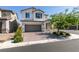 Charming two-story home with a well-manicured front yard and a brick-paved driveway at 6442 Kobe Knoll Ct, Las Vegas, NV 89141