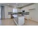 Spacious kitchen with island, stainless steel appliances, granite countertops, and white cabinetry at 6442 Kobe Knoll Ct, Las Vegas, NV 89141