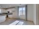 Bright eat-in kitchen with white cabinets, granite countertops, mosaic backsplash, and tile floors at 6442 Kobe Knoll Ct, Las Vegas, NV 89141