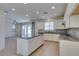 Bright open kitchen featuring an island, stainless appliances, and white cabinets with tile flooring at 6442 Kobe Knoll Ct, Las Vegas, NV 89141