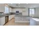 Well-lit kitchen featuring a central island with decorative accents and modern appliances at 6442 Kobe Knoll Ct, Las Vegas, NV 89141