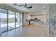 Open floor plan with kitchen featuring granite countertops, tile backsplash, and sliding door to backyard at 6442 Kobe Knoll Ct, Las Vegas, NV 89141