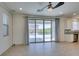 Bright living room with sliding doors leading to a patio and an open flow to the kitchen at 6442 Kobe Knoll Ct, Las Vegas, NV 89141