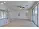 Spacious living room with stylish decorative wall feature, ceiling fan, and sliding glass doors to the outside at 6442 Kobe Knoll Ct, Las Vegas, NV 89141