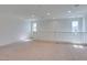 Open loft features neutral carpet and white walls offering a blank canvas for personalization at 6442 Kobe Knoll Ct, Las Vegas, NV 89141