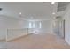 Bright open loft area with neutral carpet, white walls, and staircase railing, ready for flexible living at 6442 Kobe Knoll Ct, Las Vegas, NV 89141