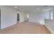 Spacious loft with neutral carpet and white walls, offering versatility and connection between rooms at 6442 Kobe Knoll Ct, Las Vegas, NV 89141