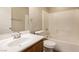 Well-lit bathroom with a single sink vanity, toilet, and a shower-tub combo with white tile surround at 6591 Gertrude Ct, Las Vegas, NV 89141