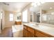 Bright Primary bathroom featuring a soaking tub, double sinks, tile floors and a separate shower at 6591 Gertrude Ct, Las Vegas, NV 89141