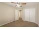 Comfortable carpeted bedroom with ceiling fan and closet at 6591 Gertrude Ct, Las Vegas, NV 89141